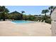 Community pool with lounge chairs surrounded by lush landscaping and mature palm trees at 2729 Hidden Lake Blvd # D, Sarasota, FL 34237