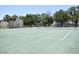 Community tennis courts, surrounded by trees and adjacent to residential buildings at 2729 Hidden Lake Blvd # D, Sarasota, FL 34237