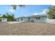 Backyard view of paver patio, fence, detached shed and grass at 2825 Pinecrest St, Sarasota, FL 34239