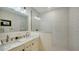 This bathroom features double sinks with a white marble countertop and a subway-tiled walk-in shower at 2825 Pinecrest St, Sarasota, FL 34239
