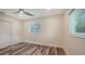 Bedroom with hardwood flooring, neutral walls, ceiling fan and two windows at 2825 Pinecrest St, Sarasota, FL 34239