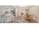 Bright dining area with wooden table and chairs next to kitchen with white cabinets and stainless steel appliances at 2825 Pinecrest St, Sarasota, FL 34239