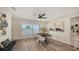Bright dining room features modern decor, a black table, stylish chairs, and a ceiling fan at 2825 Pinecrest St, Sarasota, FL 34239