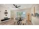 Bright dining room features modern decor, an oval table, stylish chairs, and a ceiling fan at 2825 Pinecrest St, Sarasota, FL 34239