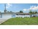 Ranch style home features a well manicured lawn and attractive landscaping for curb appeal at 2825 Pinecrest St, Sarasota, FL 34239