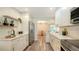 Bright kitchen featuring white cabinets, stainless steel appliances, and a view into the dining area at 2825 Pinecrest St, Sarasota, FL 34239