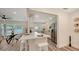 Open-concept kitchen and dining area with modern finishes, white cabinetry, and stainless steel appliances at 2825 Pinecrest St, Sarasota, FL 34239