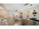 Open-concept living space with modern furniture, ceiling fan, and access to outdoor seating area at 2825 Pinecrest St, Sarasota, FL 34239