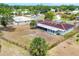 Aerial view of the house in a well-treed neighborhood, featuring a large fenced backyard at 3432 Pine Valley Dr, Sarasota, FL 34239