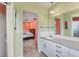Bathroom offering shower and vanity with view into the bedroom at 3432 Pine Valley Dr, Sarasota, FL 34239