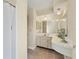 Bright bathroom featuring a long vanity and mirror, and a shower with white curtain at 3432 Pine Valley Dr, Sarasota, FL 34239