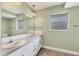 A bathroom with double sinks, ample countertop space, and neutral decor at 3432 Pine Valley Dr, Sarasota, FL 34239