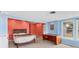 A bedroom with adjacent sunroom, tile floors, and a built-in desk area at 3432 Pine Valley Dr, Sarasota, FL 34239