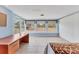 A bright bedroom with tile floors, three large windows, and a desk at 3432 Pine Valley Dr, Sarasota, FL 34239