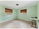 A bedroom with tile flooring, two windows, and a table at 3432 Pine Valley Dr, Sarasota, FL 34239