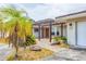 Welcoming entrance featuring a pergola, brick pathway, and mature landscaping elements at 3432 Pine Valley Dr, Sarasota, FL 34239