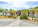 Inviting front entrance with a pergola, brick pathway, and lush landscaping at 3432 Pine Valley Dr, Sarasota, FL 34239