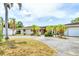 Charming single-story home featuring a pergola, red tile roof, and circular driveway at 3432 Pine Valley Dr, Sarasota, FL 34239