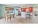 An open kitchen and dining area with stainless steel appliances, tile flooring and colorful walls at 3432 Pine Valley Dr, Sarasota, FL 34239