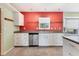 Bright kitchen featuring white cabinets, stainless steel appliances, and a window over the sink at 3432 Pine Valley Dr, Sarasota, FL 34239