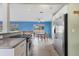 Eat-in kitchen features stainless refrigerator, range, tile flooring, and plenty of room for dining at 3432 Pine Valley Dr, Sarasota, FL 34239