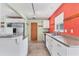 Bright kitchen features white cabinets and stainless steel refrigerator at 3432 Pine Valley Dr, Sarasota, FL 34239