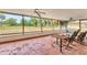 Relaxing screened patio with comfortable seating, ceiling fans, and a view of the spacious backyard at 3432 Pine Valley Dr, Sarasota, FL 34239