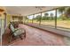 Inviting screened patio featuring ample seating and serene views of the expansive green backyard at 3432 Pine Valley Dr, Sarasota, FL 34239