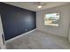 Bedroom with tile flooring, a dark accent wall, window, and a ceiling fan at 354 Lasayette Ne Dr, Port Charlotte, FL 33952