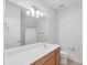 Bathroom featuring a large mirror, a vanity with wood cabinets, and a shower-tub combo at 3760 82Nd Avenue E Cir # 102, Sarasota, FL 34243