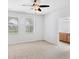 Bright bedroom with ceiling fan, two windows and view of the ensuite bathroom at 3760 82Nd Avenue E Cir # 102, Sarasota, FL 34243
