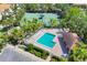 Beautiful community pool with lounge chairs, set alongside a tennis court and manicured landscaping at 3760 82Nd Avenue E Cir # 102, Sarasota, FL 34243