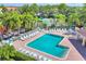 Inviting community pool, complete with lounge chairs and umbrellas, nestled near a tennis court and playground at 3760 82Nd Avenue E Cir # 102, Sarasota, FL 34243