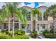 The exterior of a well-maintained townhome featuring tropical landscaping and a classic design at 3760 82Nd Avenue E Cir # 102, Sarasota, FL 34243