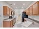 Spacious kitchen featuring granite countertops, wood cabinets, and modern appliances at 3760 82Nd Avenue E Cir # 102, Sarasota, FL 34243
