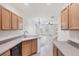 Bright kitchen with light wood cabinets, stainless steel appliances and an open layout to the living area at 3760 82Nd Avenue E Cir # 102, Sarasota, FL 34243