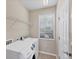 Laundry room featuring a washer, dryer, window, and storage shelf at 3760 82Nd Avenue E Cir # 102, Sarasota, FL 34243
