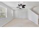 Bright living area featuring fresh paint, ceiling fan, and staircase at 3760 82Nd Avenue E Cir # 102, Sarasota, FL 34243