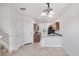 Open concept living area with chandelier and staircase to the second floor at 3760 82Nd Avenue E Cir # 102, Sarasota, FL 34243
