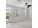 Bright living room with neutral carpet, ceiling fan, and a door to the outside at 3760 82Nd Avenue E Cir # 102, Sarasota, FL 34243