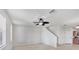 Spacious living room featuring ceiling fan, stairs, and view into kitchen at 3760 82Nd Avenue E Cir # 102, Sarasota, FL 34243