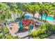Well-maintained community playground with colorful equipment, adjacent to the pool and tennis courts at 3760 82Nd Avenue E Cir # 102, Sarasota, FL 34243