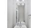 Powder room featuring a modern mirror over a small sink, with a light and airy feel at 3760 82Nd Avenue E Cir # 102, Sarasota, FL 34243
