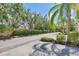 Beautiful street lined with palm trees and lush landscaping creates a serene atmosphere at 3760 82Nd Avenue E Cir # 102, Sarasota, FL 34243