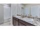 Bathroom with double sinks, granite countertops, wood cabinets, tiled floors and a bathtub at 3835 Turning Tides Ter, Bradenton, FL 34208