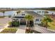 Exterior view of community building, features include a well-manicured landscape, palm trees, and a parking lot at 3835 Turning Tides Ter, Bradenton, FL 34208