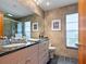 Bathroom with double sink vanity, large mirror, and a glass-enclosed shower at 3905 Country View Dr, Sarasota, FL 34233