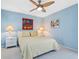 Inviting bedroom with comfortable bed, bright natural light, and ceiling fan at 3905 Country View Dr, Sarasota, FL 34233