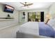 Spacious bedroom with TV, shelving and direct access to outdoor living space with pool at 3905 Country View Dr, Sarasota, FL 34233