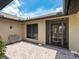 Exterior patio with glass front door, brick-paved patio with seating at 3905 Country View Dr, Sarasota, FL 34233